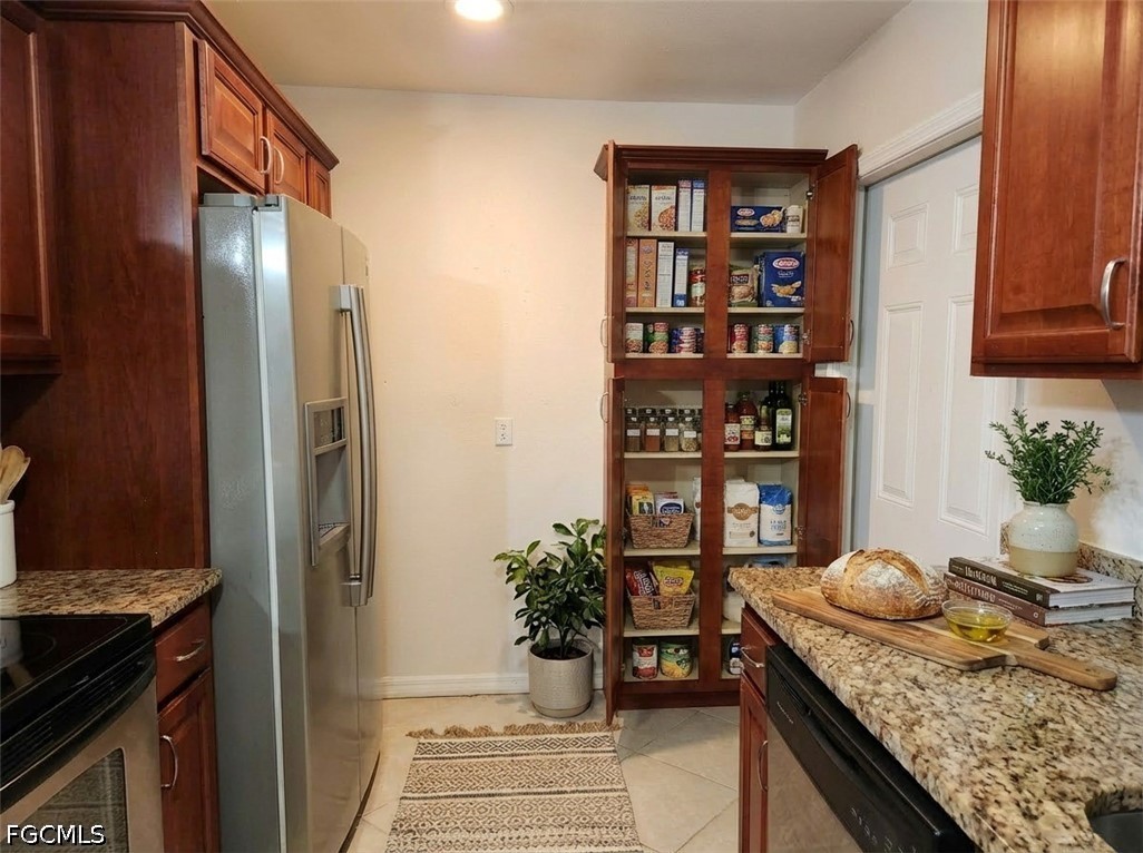 3417 19th Street Southwest Lehigh Acres, FL 33976 - Photo 5 of 14 a kitchen with a refrigerator and a stove