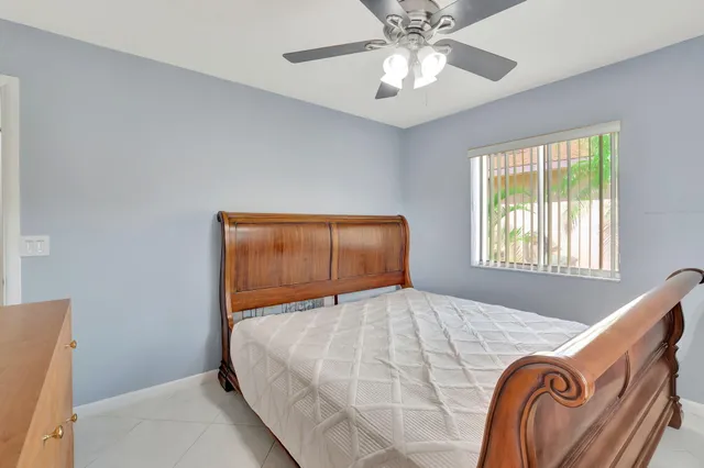 a bathroom with a granite countertop sink a toilet and a mirror