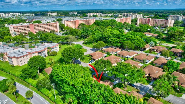an aerial view of residential houses with outdoor space and trees