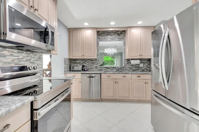 a kitchen with stainless steel appliances refrigerator and cabinets
