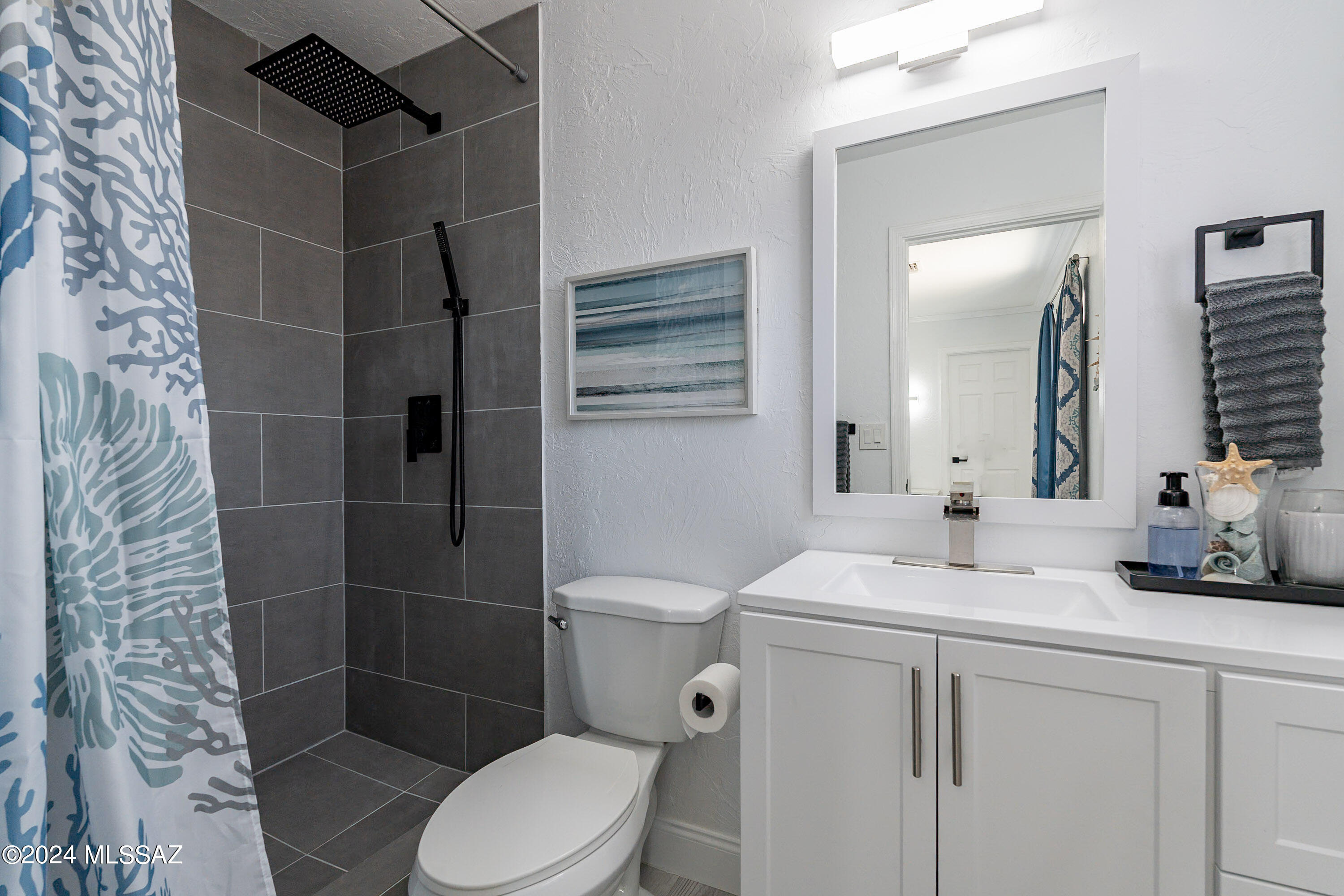 1009 Calle Coyote Rio Rico, AZ 85648 - Photo 18 of 28 a bathroom with a sink toilet and shower
