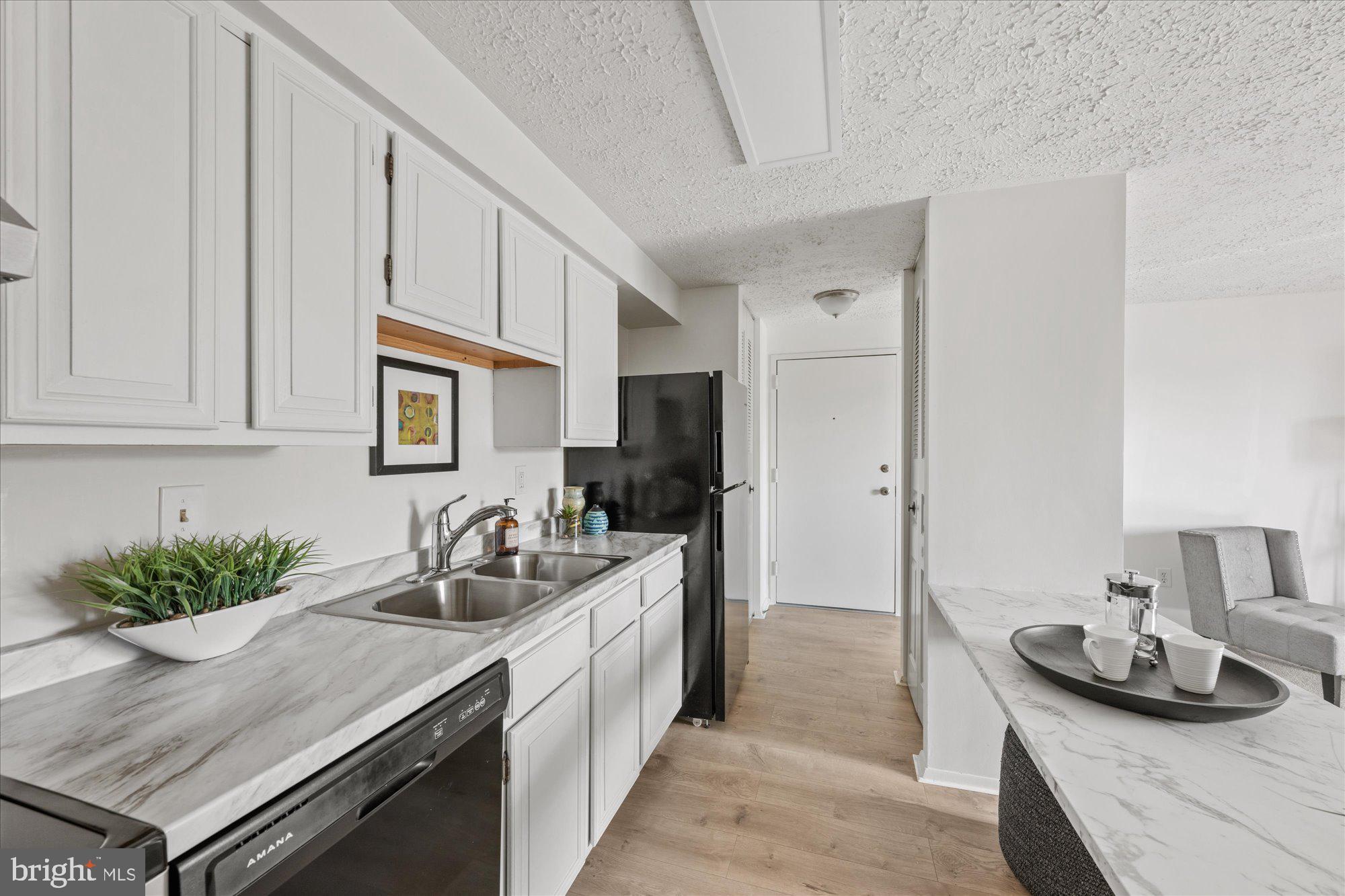 19517 Gunners Branch Road, Unit 431 Germantown, MD 20876 - Photo 4 of 23 a kitchen with stainless steel appliances granite countertop a sink stove and cabinets