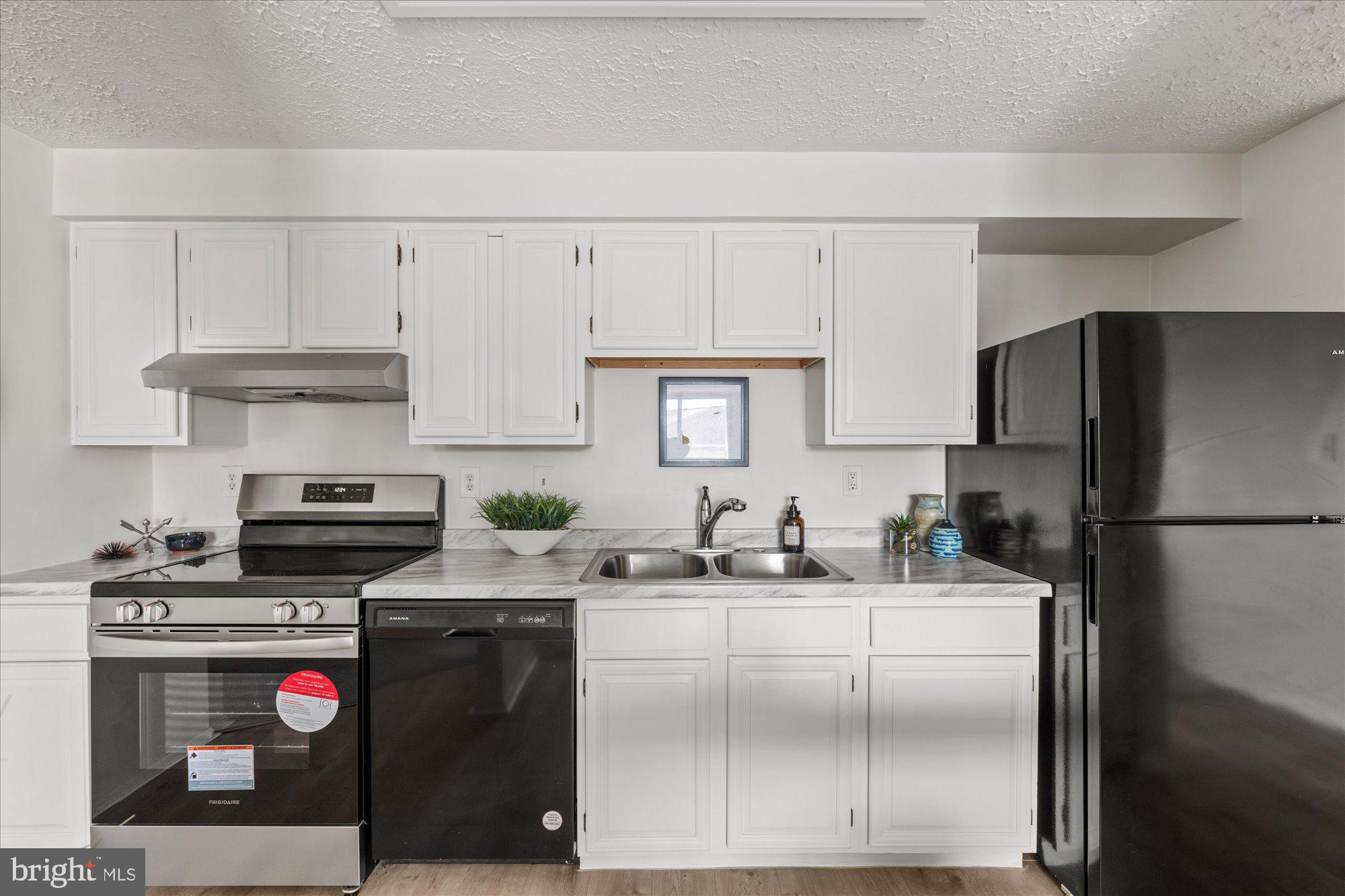 19517 Gunners Branch Road, Unit 431 Germantown, MD 20876 - Photo 6 of 23 a kitchen with stainless steel appliances granite countertop a refrigerator stove and sink