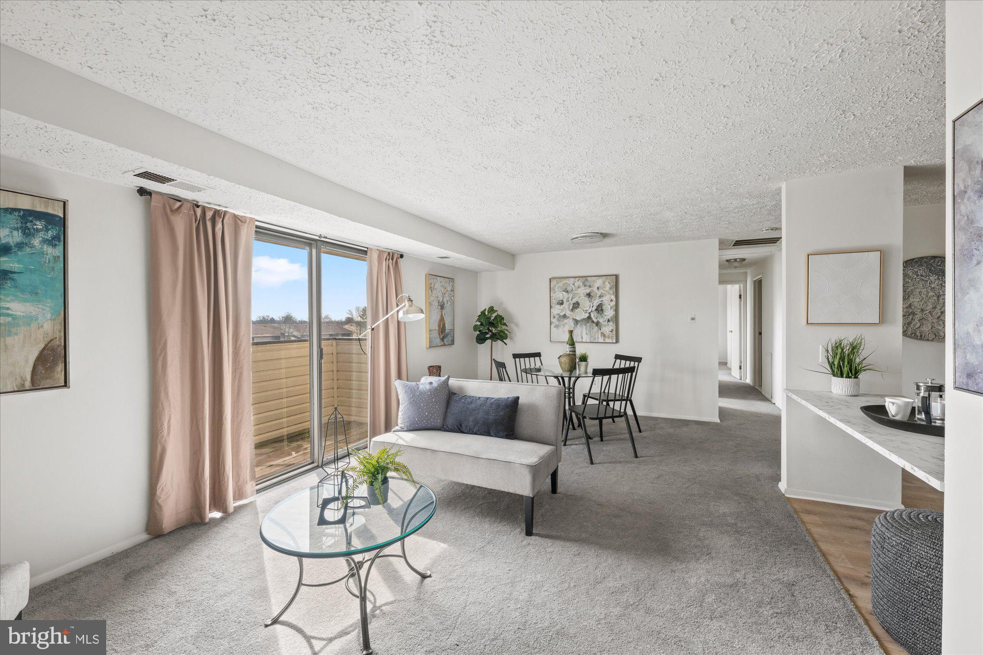 19517 Gunners Branch Road, Unit 431 Germantown, MD 20876 - Photo 8 of 23 a living room with furniture and a large window