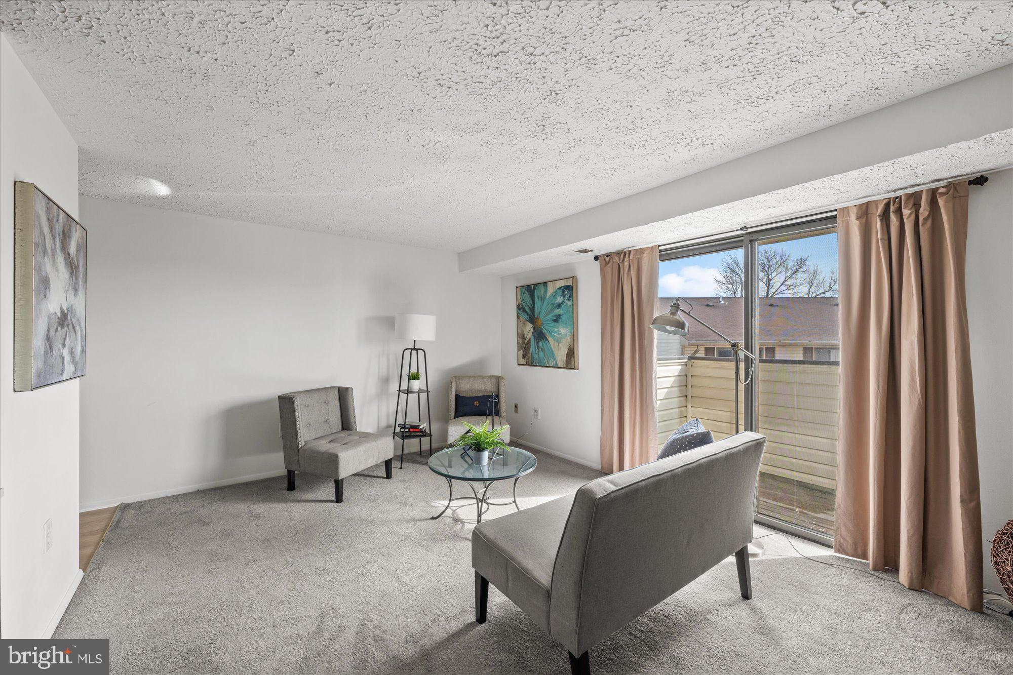 19517 Gunners Branch Road, Unit 431 Germantown, MD 20876 - Photo 9 of 23 a living room with furniture and a large window