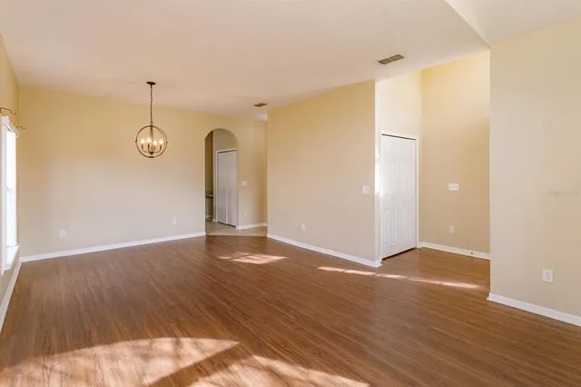 a view of a room with wooden floor and white walls