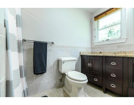 5 Lantern Road Andover, MA 01810 - Photo 21 of 32 a bathroom with a granite countertop toilet sink and mirror
