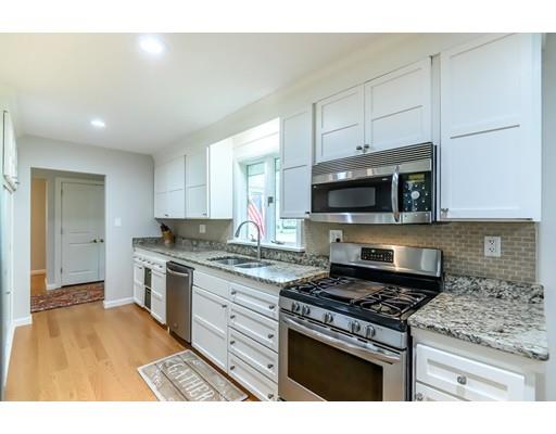 5 Lantern Road Andover, MA 01810 - Photo 4 of 32 a kitchen with stainless steel appliances kitchen island granite countertop a stove a sink and a microwave