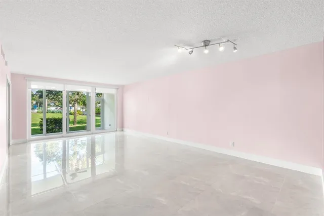 an empty room with floor to ceiling windows