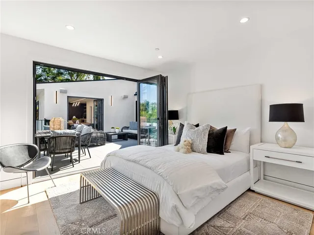 a bedroom with a bed and a large window