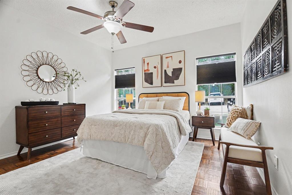 14277 Preston Road, Unit 315 Dallas, TX 75254 - Photo 6 of 20 Spacious bedroom with dual closets, ceiling fan, ensuite bath, and room for armoire.