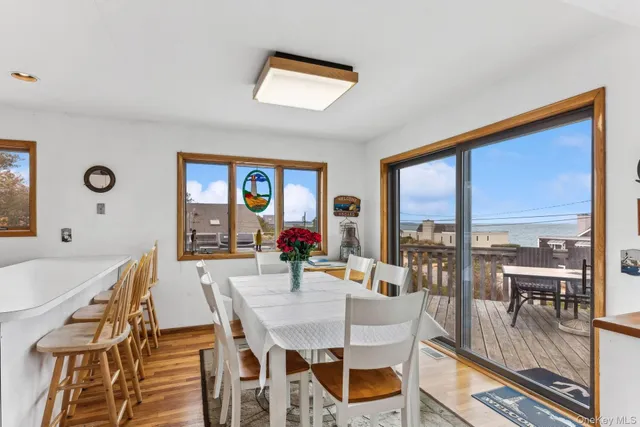 a view of a dining room with furniture large windows and wooden floor