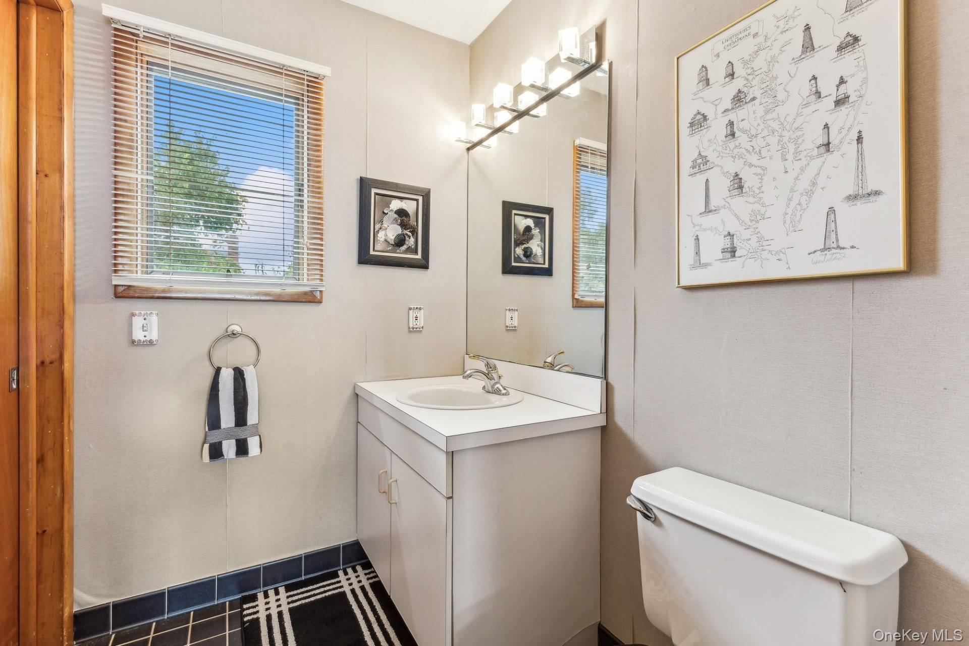 21 Captain Kidds Path Montauk, NY 11954 - Photo 24 of 30 a bathroom with a toilet sink and mirror