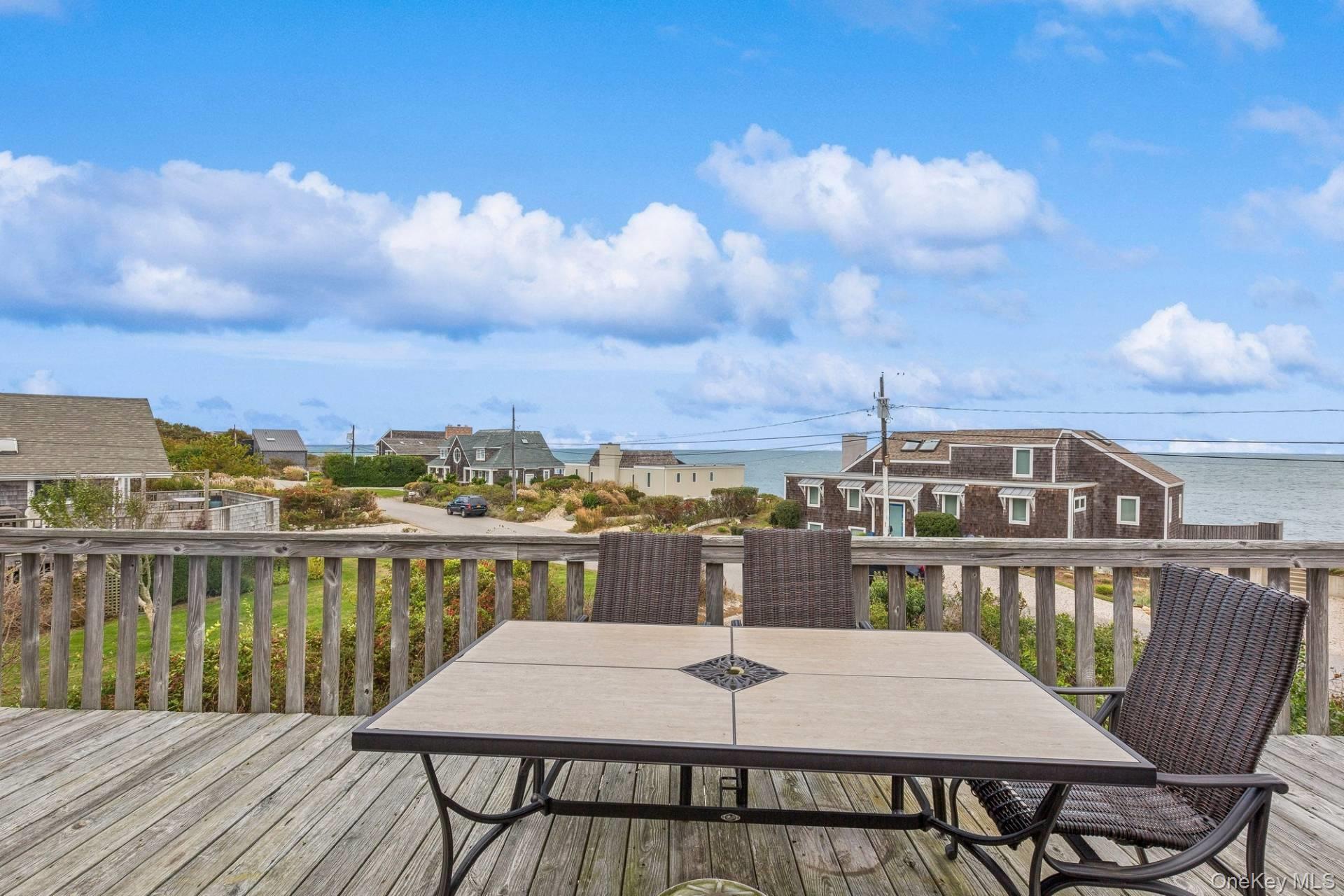21 Captain Kidds Path Montauk, NY 11954 - Photo 26 of 30 a view of a roof deck with chair and wooden floor