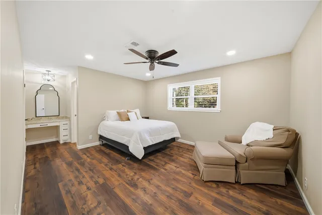 a bedroom with a bed couch and window