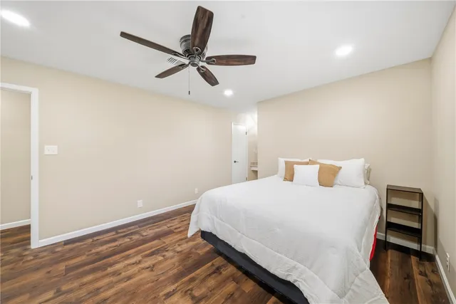 a bedroom with a bed and a ceiling fan