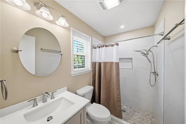 a bathroom with a sink toilet and shower