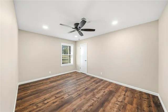 a view of room with window and ceiling fan