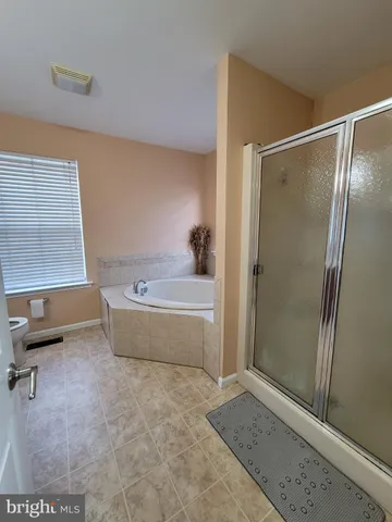 a bathroom with a tub and a shower