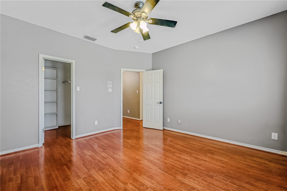 5917 Harvest Hill Road Corpus Christi, TX 78414 - Photo 29 of 40 an empty room with wooden floor a ceiling fan and closet