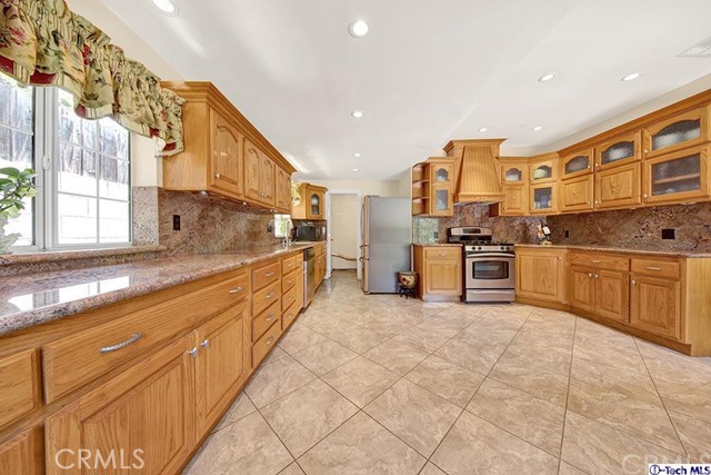 2086 Maiden Lane Altadena, CA 91001 - Photo 8 of 21 a large kitchen with stainless steel appliances granite countertop a stove and cabinets