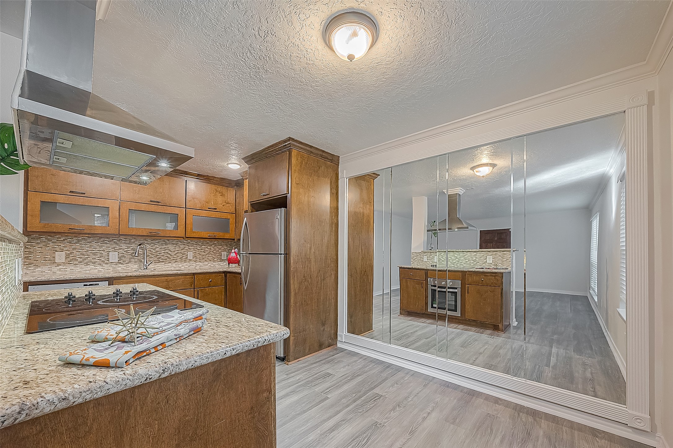 3224 Timmons Lane, Unit 147 Houston, TX 77027 - Photo 11 of 32 a kitchen with stainless steel appliances granite countertop a sink and a refrigerator