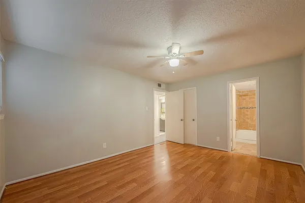 a view of an empty room with wooden floor