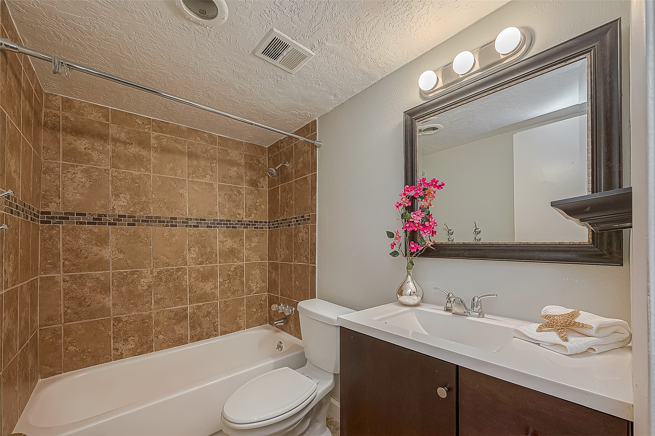 3224 Timmons Lane, Unit 147 Houston, TX 77027 - Photo 19 of 32 a bathroom with a sink vanity mirror and toilet