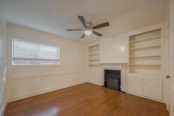 a view of an empty room with a fireplace and a window