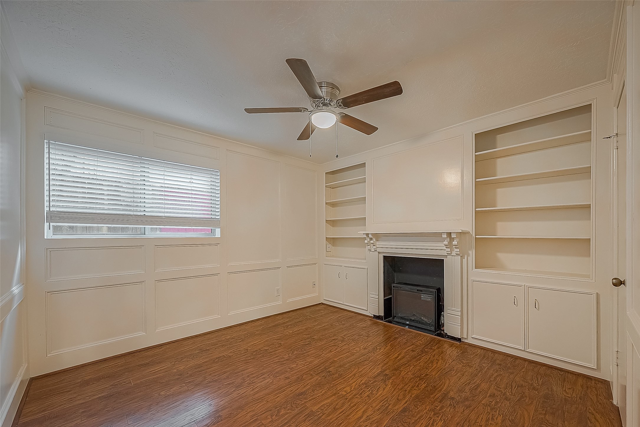 3224 Timmons Lane, Unit 147 Houston, TX 77027 - Photo 21 of 32 a view of an empty room with a fireplace and a window