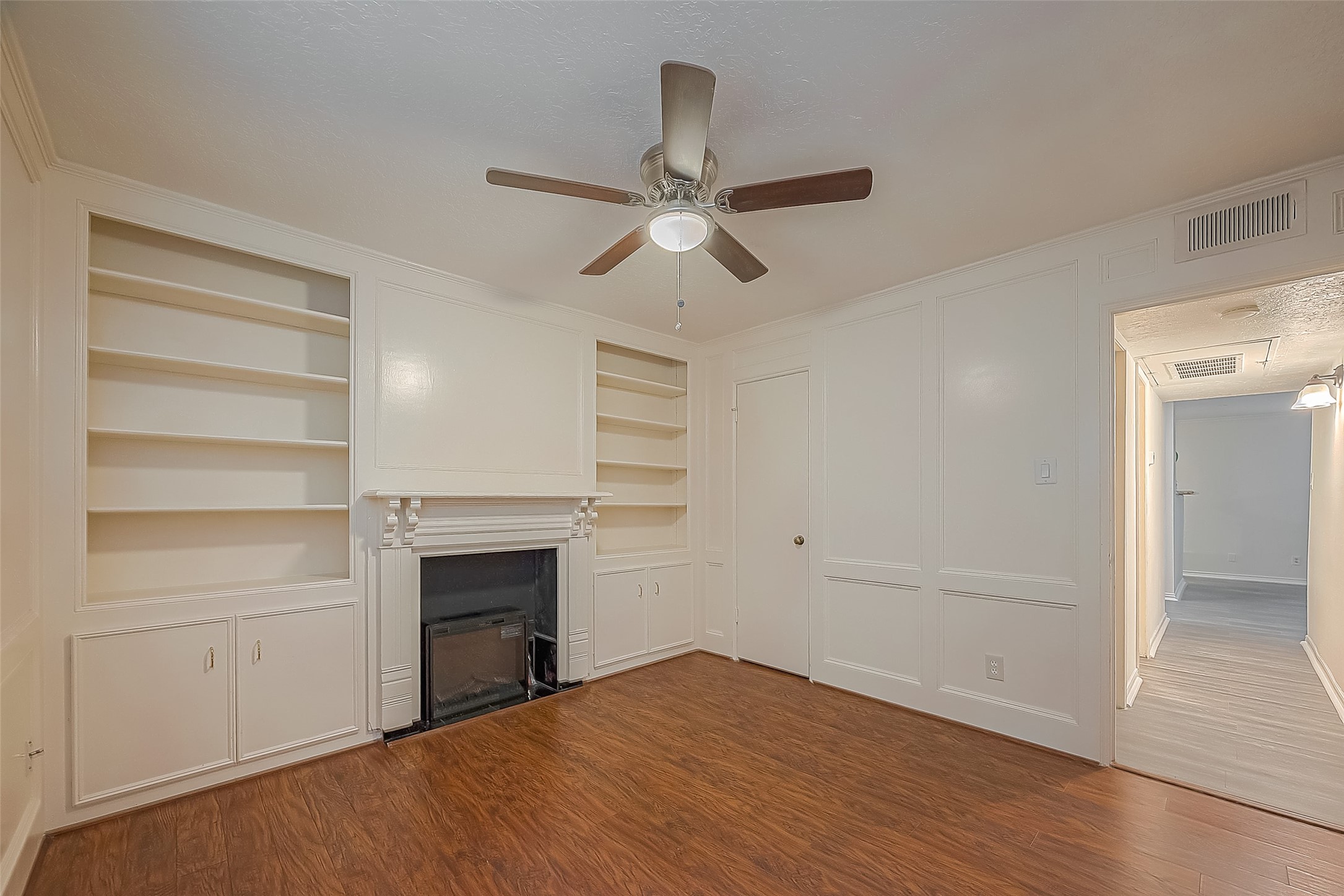 3224 Timmons Lane, Unit 147 Houston, TX 77027 - Photo 22 of 32 a view of empty room with a fireplace and ceiling fan