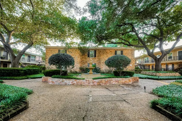 a backyard of a house with lots of green space and fountain