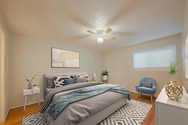 a bedroom with a bed and wooden floor
