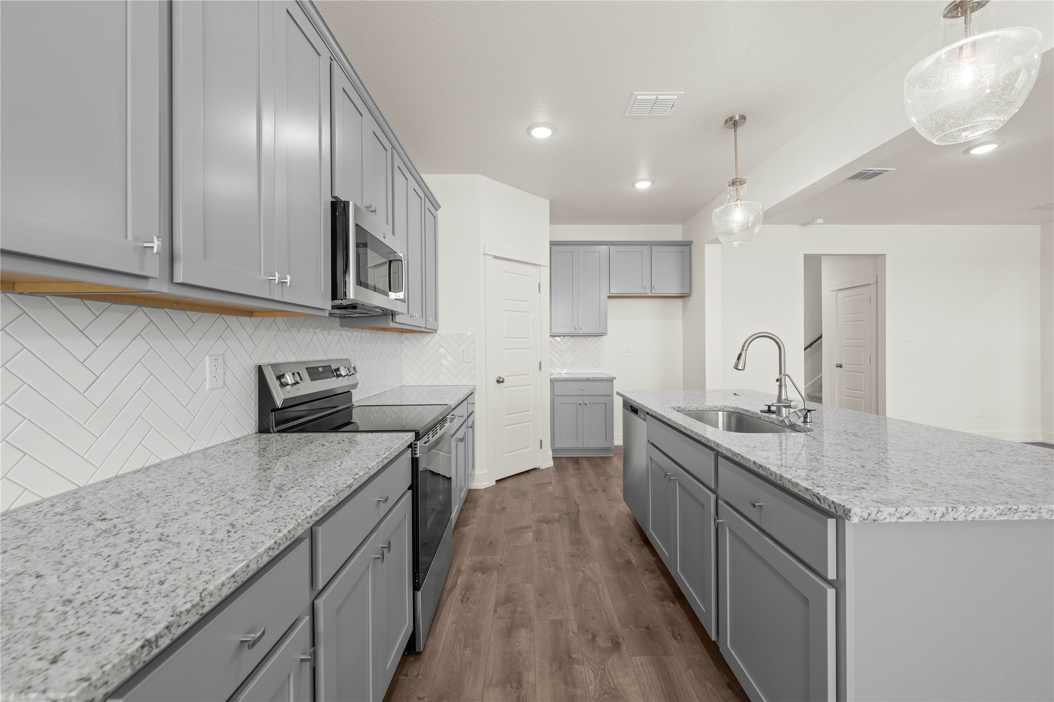 564 Gus Loop Georgetown, TX 78626 - Photo 4 of 32 a kitchen with stainless steel appliances granite countertop a sink stove and cabinets