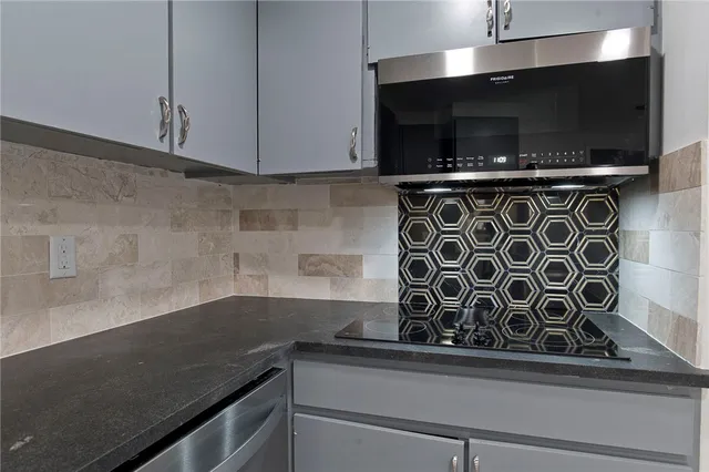 a sink a microwave and cabinets