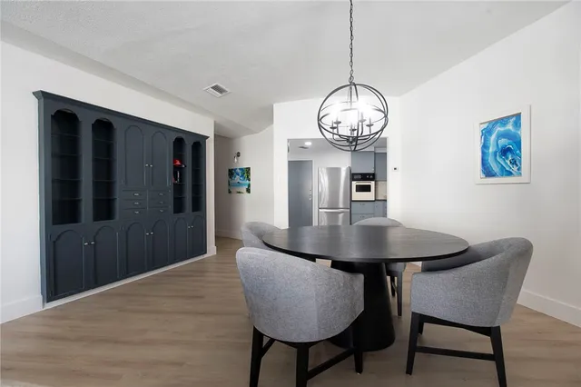 a view of a dining room with a table and chairs