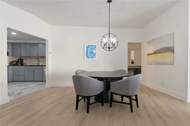 a view of a dining room with furniture wooden floor and a chandelier