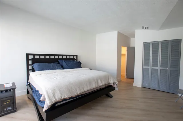 a bedroom with a bed and closet