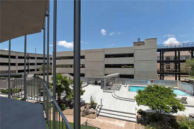 a view of a patio with chairs and potted plants