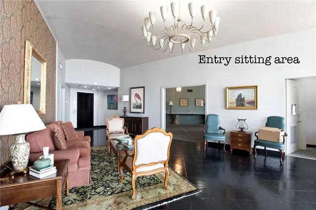 a living room with furniture a fireplace and a table