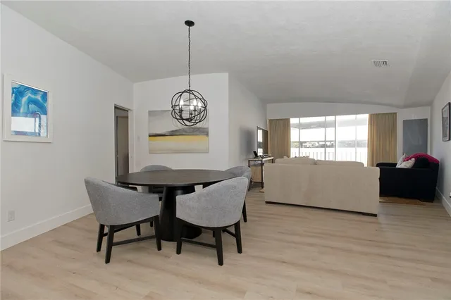 a living room with furniture wooden floor and a window