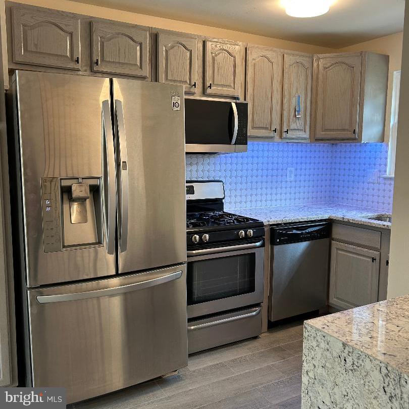 80 Via Cascata Drive Clementon, NJ 08021 - Photo 11 of 26 a kitchen with stainless steel appliances and wooden cabinets