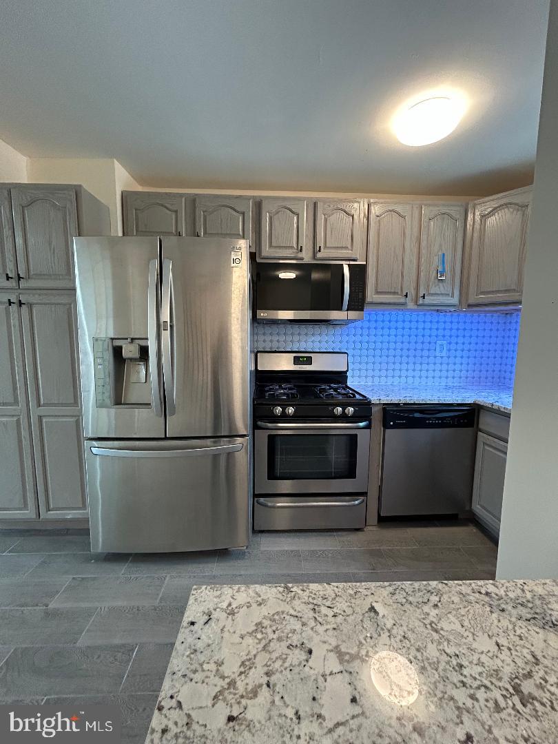 80 Via Cascata Drive Clementon, NJ 08021 - Photo 9 of 26 a kitchen with stainless steel appliances granite countertop a refrigerator stove and microwave