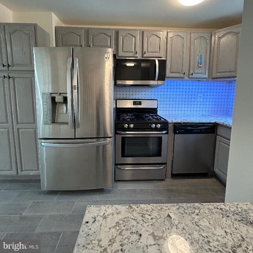 80 Via Cascata Drive Clementon, NJ 08021 - Photo 10 of 26 a kitchen with stainless steel appliances wooden cabinets a stove and a refrigerator