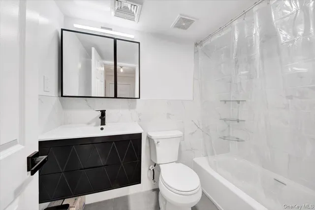 a bathroom with a toilet a sink and bathtub