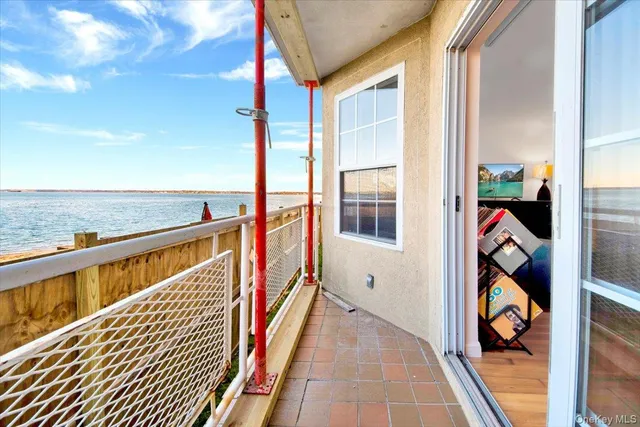 a bedroom with a bed a couch and a flat screen tv