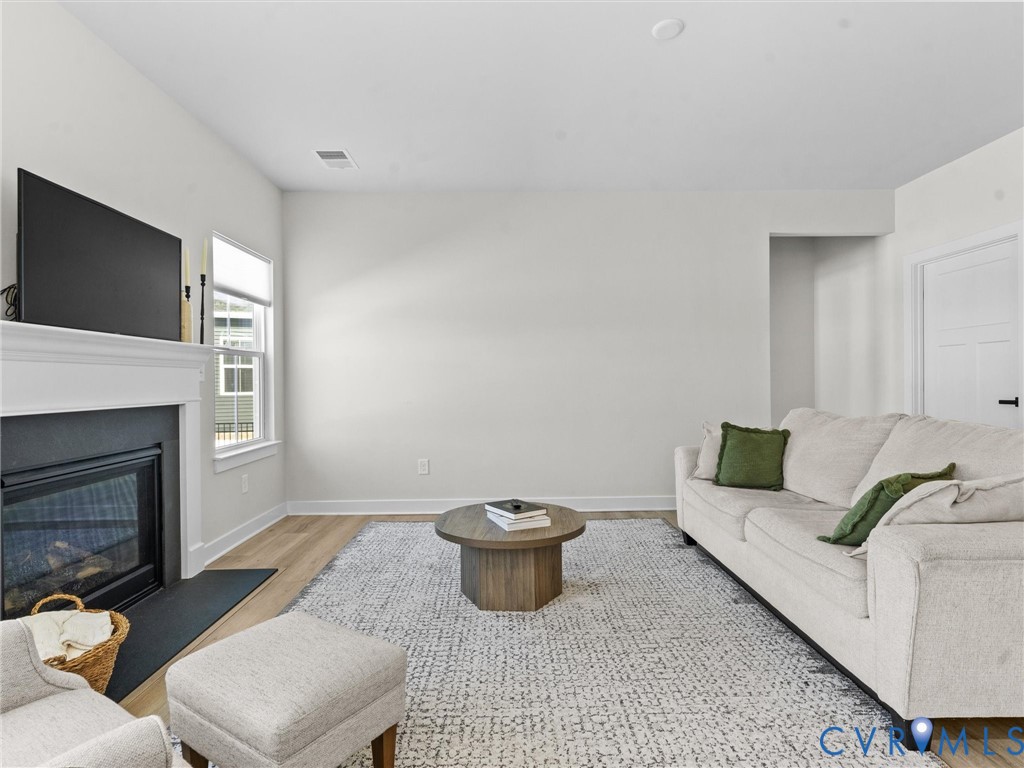 6230 Sheehan Crossing Moseley, VA 23120 - Photo 14 of 32 a living room with furniture and a fireplace