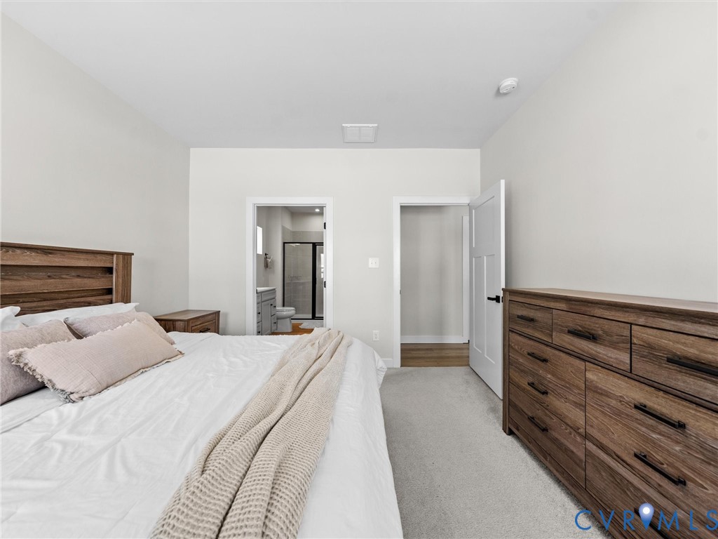 6230 Sheehan Crossing Moseley, VA 23120 - Photo 24 of 32 a bedroom with a bed and a dresser