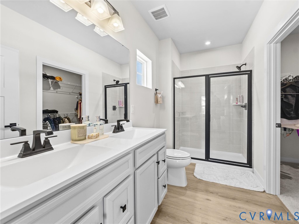 6230 Sheehan Crossing Moseley, VA 23120 - Photo 25 of 32 a bathroom with a double vanity sink mirror and toilet