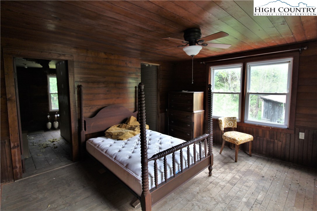 1419 Joe Hampton Road Lansing, NC 28643 - Photo 11 of 25 a bedroom with furniture and a large window
